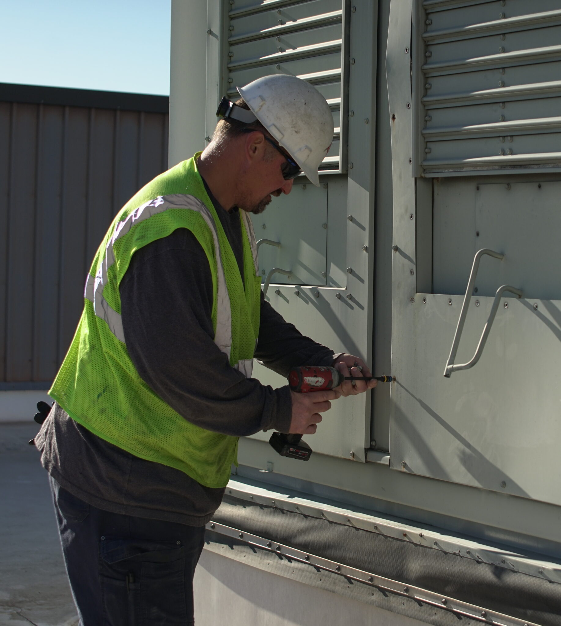 DMC commercial HVAC contractor inspecting rooftop equipment