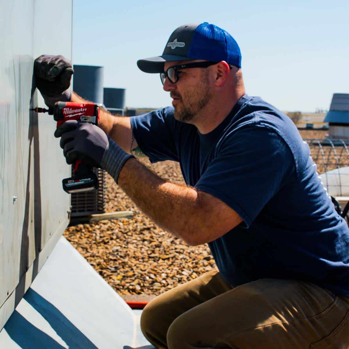 DMC technician installing a commercial rooftop HVAC unit