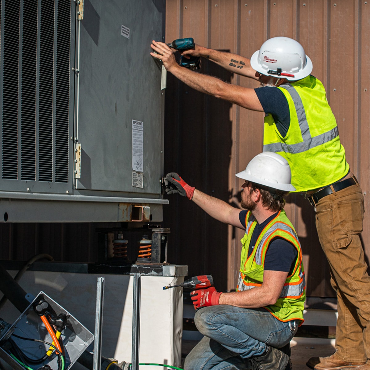 DMC HVAC team working on a commercial split system