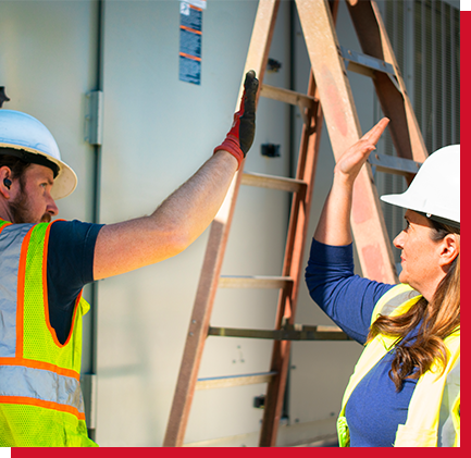 2 workers high fiving