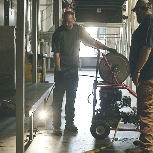 DMC technicians working on industrial HVAC systems piping