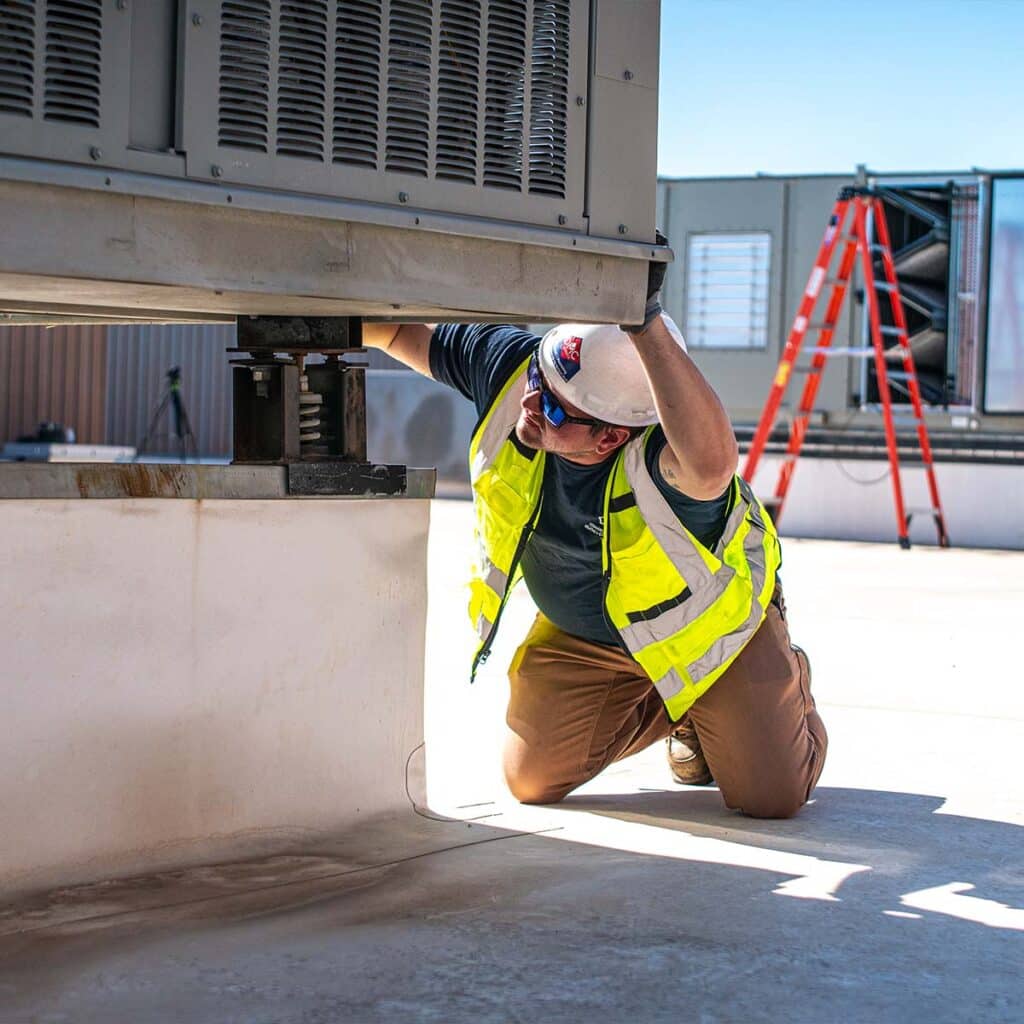 DMC HVAC technician inspects split system